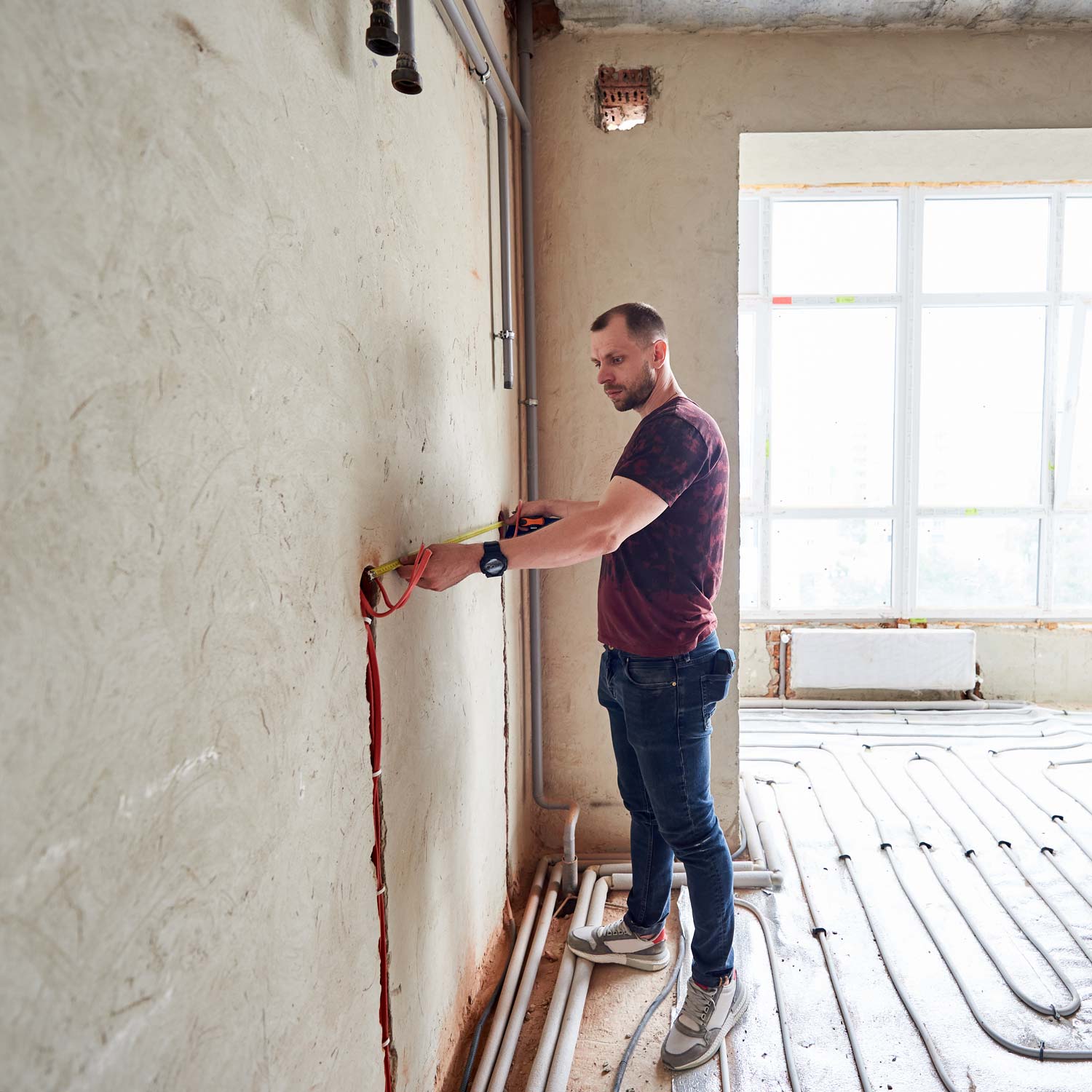 man working on underfloor heat system